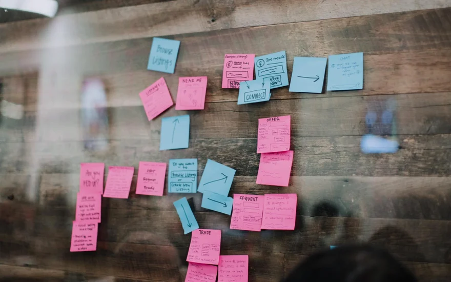 Sticky-note user flow on a wooden wall: browse listings, near me, offer, request, trade, connect and chat.